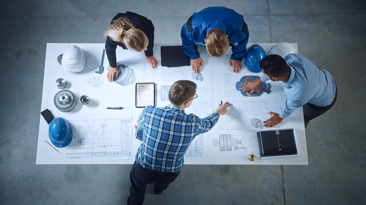 a group of engineers reviewing their peer-to-peer collaboration strategy
